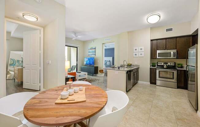 a kitchen and dining room with a wooden table and chairs