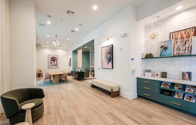 A modern living room with a wooden floor and a green sofa.