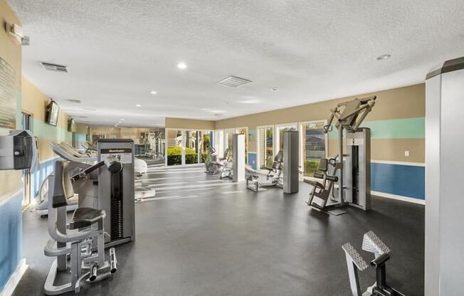 a gym with a lot of weights and cardio equipment