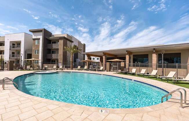 A swimming pool in front of apartment buildings.