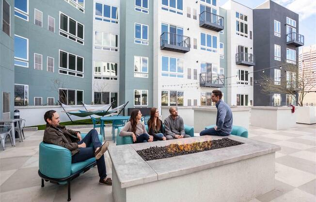 Rooftop patio with people sitting next to a fire pit at Circa Central Avenue
