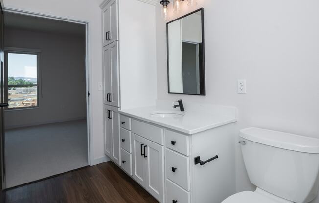 an empty bathroom with a toilet sink and mirror at The Crossings at Windsong, Arizona, 86314