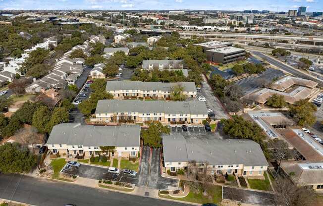 A large building complex with a parking lot in front.