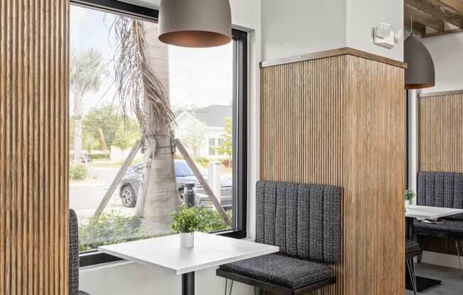 a dining area with a table and chairs and a window at The Sophia, Venice, FL, 34275