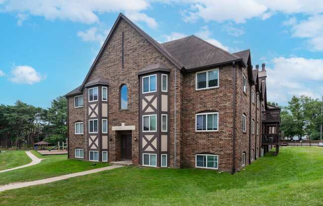 an apartment building with a brick exterior and a brown and tan facade
