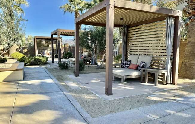 a covered patio with a couch and a table