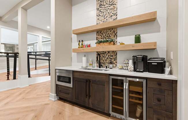A kitchen with a wooden floor and a white wall.