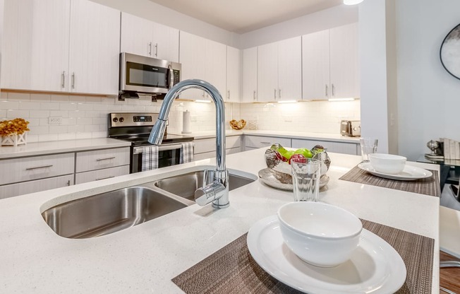 a kitchen with a sink and a counter with a bowl on it