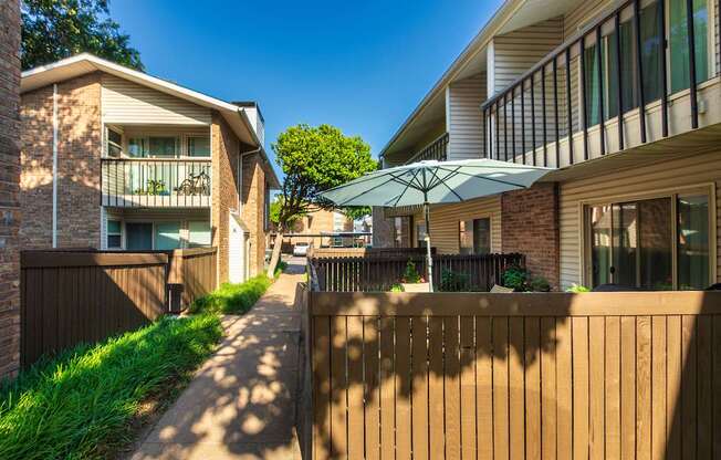 Apartment building exteriors showing patios, balconies and landscaping at Preston Park Apartments in the Far North Dallas neighborhood of Dallas, TX