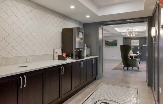 A kitchen with dark wood cabinets and a white countertop.