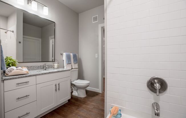 a bathroom with a shower toilet and sink at 55 Fifty at Northwest Crossing, Houston, TX 77092