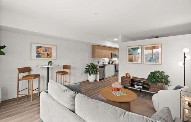 A living room with a grey couch and a coffee table.