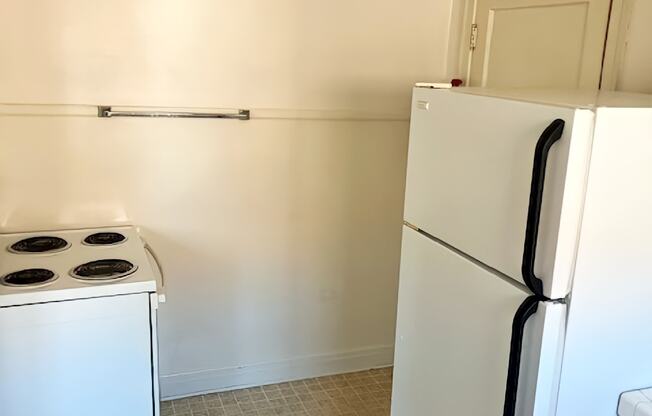 A white fridge and stove in a kitchen.
