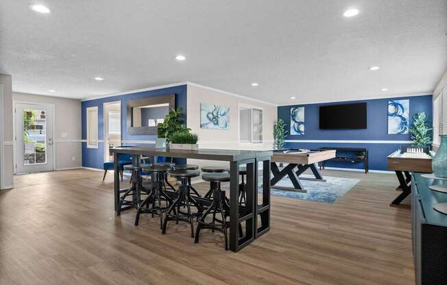 A modern kitchen with a bar area and a dining table.