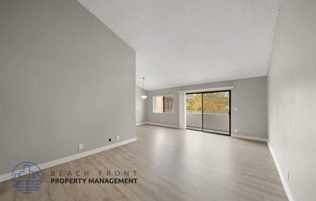 the renovated living room and dining room with wood flooring