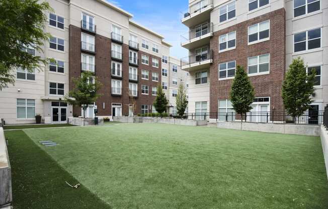 a large grassy area with trees in front of an apartment building at 200 City View, Provo, UT