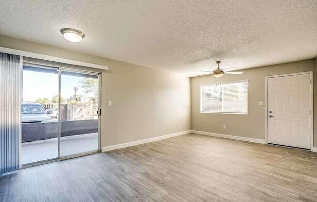 A room with a sliding glass door and a ceiling fan at Sterling Point Apartment Homes, Arizona, 85042