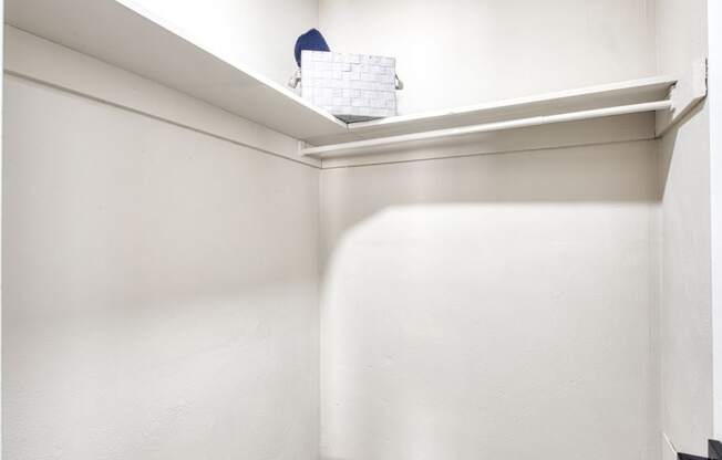 a small closet with a white wall and a shelf at Bayville Apartments, Virginia Beach, Virginia