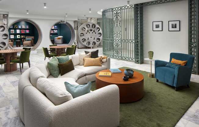 A living room with a white sofa and a green rug.