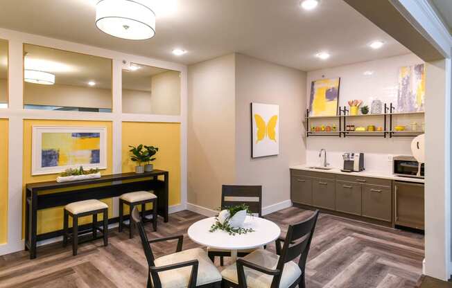 a dining room with a table and chairs and a kitchen