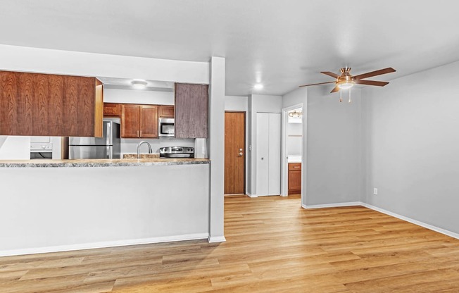 A kitchen with wooden cabinets and a white countertop.