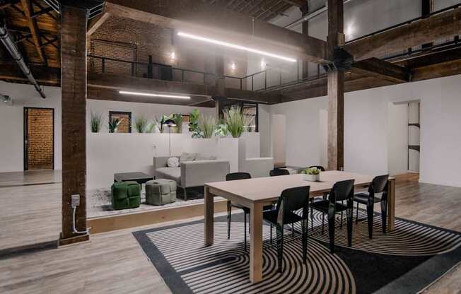 A modern dining area with a wooden table and chairs.