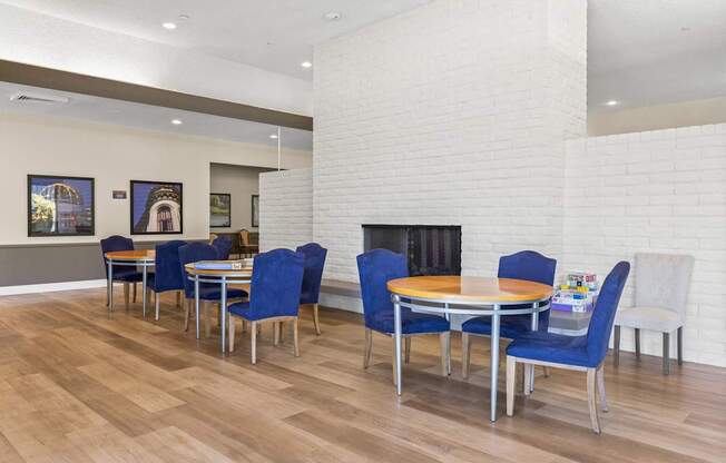 A white brick fireplace with a fire going in it.