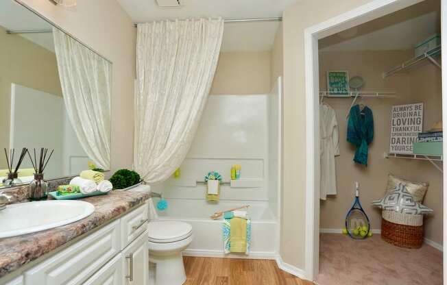 a bathroom with a toilet and a sink and a shower