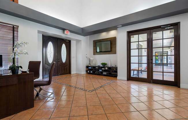 A room with a brown tile floor and a brown chair.