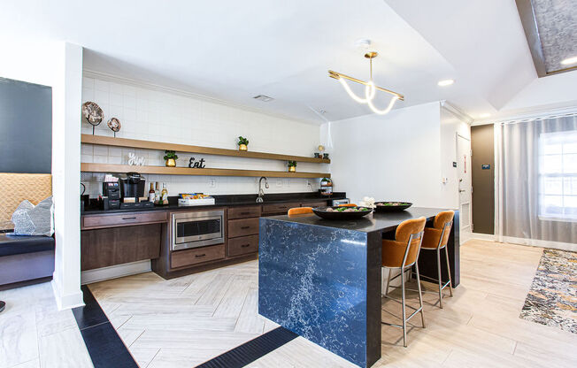 a kitchen with a blue counter top and a table with chairs