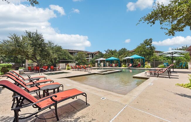 the preserve at ballantyne commons community swimming pool with red benches at Lakeline East Apartments, Texas, 78613