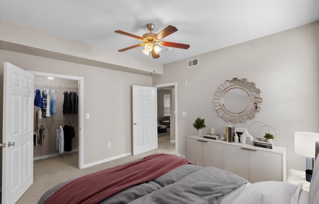 a bedroom with a large bed and a ceiling fan