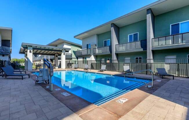 The Hedrick on Mountain Townhome-Style Apartments in Tucson, Arizona Pool with Lounge Chairs