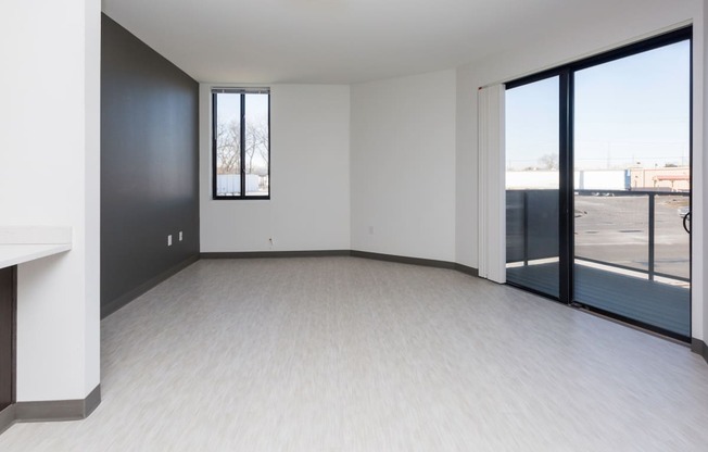 Spacious living room with neutral walls and ample natural light.