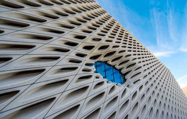 A building with a unique design and a blue sky in the background.