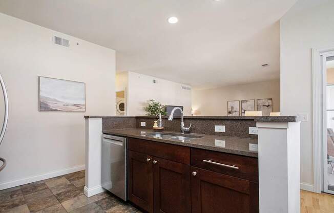 A kitchen with a white counter top and brown cabinets.