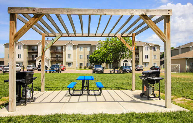 our apartments showcase a clubhouse with a picnic table and grill