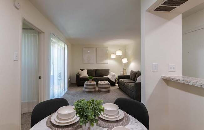 A dining table with plates and a plant on it in a 1 bedroom, 1 bath 554 sq ft apartment home at The Biltmore Apartments located in the Vickery Midtown neighborhood of Dallas, TX..