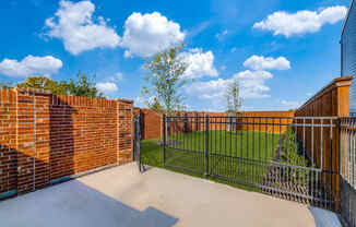 Two-Bedroom Homes for Rent in Houston, TX - East Heights - Dog Park with Green Grass, Trees, and Gated Fence.