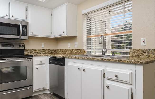 renovated kitchen with white cabinets