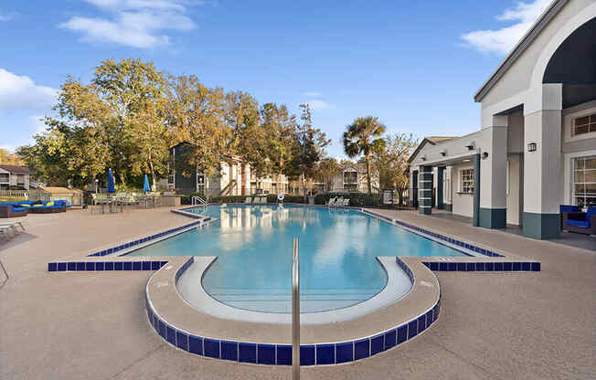 Community Swimming Pool with Pool Furniture at Vue at Baymeadows Apartments in Jacksonville, FL.