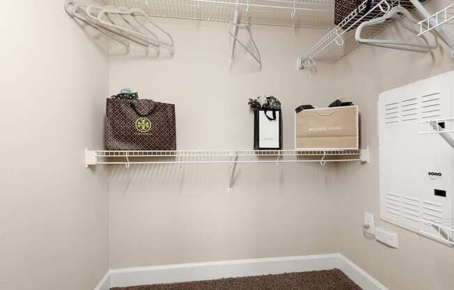 spacious laundry room with hooks and shelves and a washer and dryer