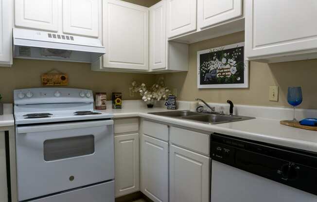a kitchen with white cabinets and white appliances