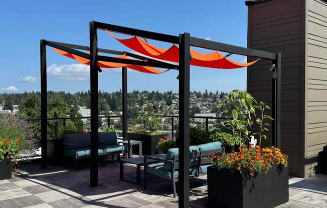 a patio with a canopy and chairs on a roof at Spyglass Hill Apartments, Bremerton, Washington