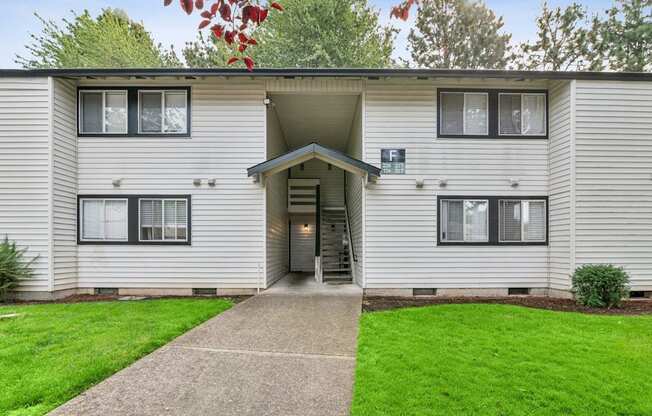 A building with a grey facade and a white door.