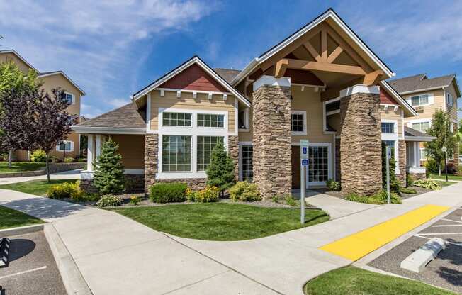entry way with a sidewalk and green grass at Quail Springs Apartments