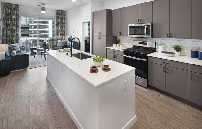 a view of a kitchen with a large island in the middle at Aura Vegas Apartments, Las Vegas, NV 89103