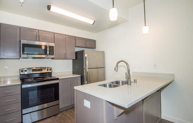 a kitchen with stainless steel appliances and a white counter top