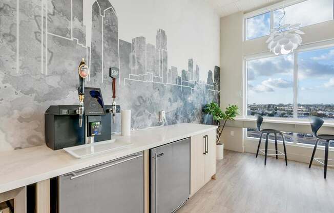 A modern kitchen with a cityscape mural on the wall.