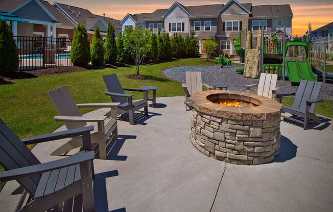 an outdoor patio with a fire pit and benches